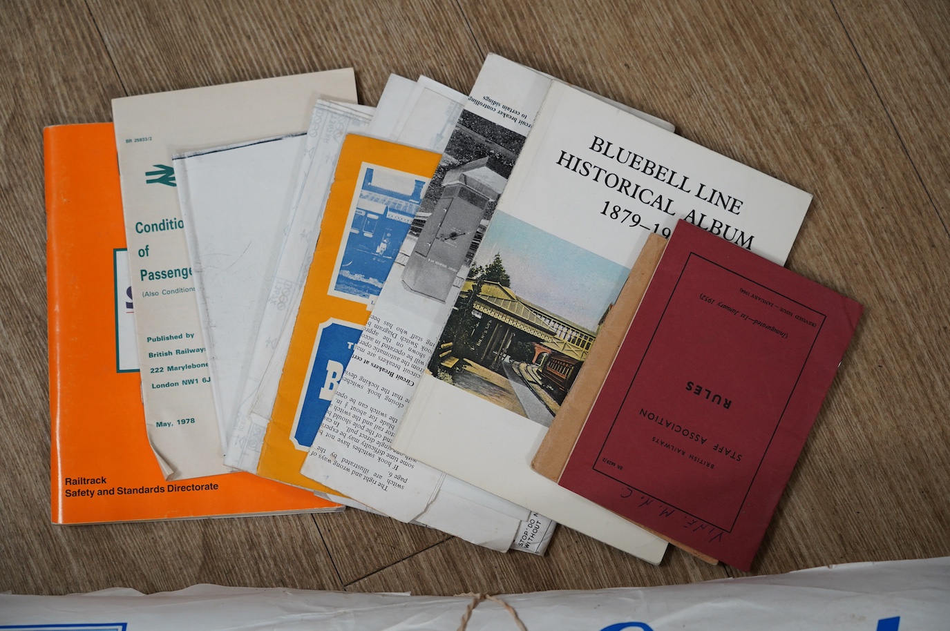 An archive of 1950s-90s railway memorabilia including; internal British railways publications, Bluebell Railway related items, a large quantity of Sussex related poster timetables, a BR rule book, NUR badges, a Gatwick E